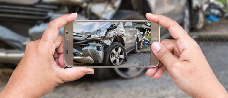 A car accident being photographed.