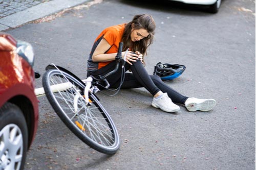 A cyclist hit by a car in a bike accident